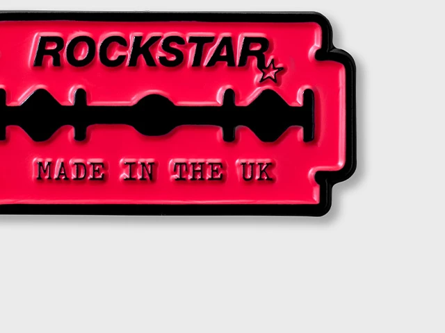 Enamel pin of a pink razor with text reading: Rockstar. Made in the UK.
